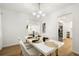Elegant dining room with modern chandelier, white table, and seamless access to the kitchen at 2905 Dale Creek Drive Nw, Atlanta, GA 30318