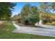 Brick home with attached garage, concrete drive, and spacious deck, surrounded by mature trees at 2905 Dale Creek Drive Nw, Atlanta, GA 30318