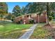 Charming brick home with a well-maintained lawn and inviting walkway, nestled among lush greenery at 2905 Dale Creek Drive Nw, Atlanta, GA 30318