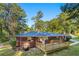 Brick home featuring a spacious rear deck surrounded by tall trees, offering privacy at 2905 Dale Creek Drive Nw, Atlanta, GA 30318