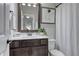 Cozy bathroom features a framed mirror, vanity, and shower with curtain at 433 Cranleigh Se Rdg, Smyrna, GA 30080