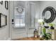 Bright entryway with a decorative mirror, stylish console table, and fresh plants creating a modern look at 433 Cranleigh Se Rdg, Smyrna, GA 30080