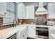 Well-equipped kitchen with stainless steel appliances, white cabinetry, and a farmhouse sink for a modern feel at 433 Cranleigh Se Rdg, Smyrna, GA 30080