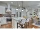 Modern kitchen boasts stainless steel appliances, white cabinets and brick backsplash, offering style and functionality at 433 Cranleigh Se Rdg, Smyrna, GA 30080