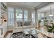Comfortable living space with hardwood floors and large windows that seamlessly flows into the dining area at 433 Cranleigh Se Rdg, Smyrna, GA 30080