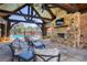 Inviting outdoor living space with stone fireplace and comfortable seating near pool at 433 Cranleigh Se Rdg, Smyrna, GA 30080