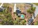 Aerial view of a private property featuring a home, an in-ground pool, and lush landscaping with a long driveway at 7500 Gillespie Pl, Douglasville, GA 30135
