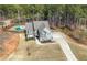 A birds eye view of a private home with a driveway, backyard pool and lush green landscaping at 7500 Gillespie Pl, Douglasville, GA 30135