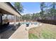 Lovely outdoor space with a covered patio, dining area, and pool, ideal for entertaining and relaxation at 7500 Gillespie Pl, Douglasville, GA 30135