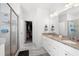 Modern bathroom with double vanity, granite countertop, walk-in shower, and closet access at 7500 Gillespie Pl, Douglasville, GA 30135