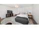 Well-lit bedroom with modern decor, including a platform bed, area rug, and entertainment center at 7500 Gillespie Pl, Douglasville, GA 30135