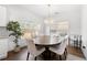 Bright dining area with large window, stylish light fixture, and wood table with seating at 7500 Gillespie Pl, Douglasville, GA 30135