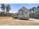 Charming two-story home boasts a gray exterior, accented by dark shutters and a well-manicured lawn at 7500 Gillespie Pl, Douglasville, GA 30135