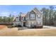 Charming two-story home featuring a landscaped yard and a welcoming front porch at 7500 Gillespie Pl, Douglasville, GA 30135