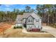 Charming two-story home with a well-manicured lawn, beautiful landscaping, and a welcoming front entrance at 7500 Gillespie Pl, Douglasville, GA 30135