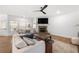 Spacious living room featuring a fireplace, hardwood floors, and views of the backyard at 7500 Gillespie Pl, Douglasville, GA 30135