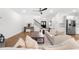 Spacious living room with hardwood floors, a fireplace, and a view of the staircase at 7500 Gillespie Pl, Douglasville, GA 30135