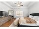 Comfortable main bedroom features a ceiling fan, large windows, and a dresser at 7500 Gillespie Pl, Douglasville, GA 30135