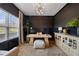 Modern home office with a unique desk, stylish light fixture, and neutral decor at 7500 Gillespie Pl, Douglasville, GA 30135