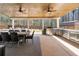 Covered outdoor kitchen with a dining table, grill, and stainless steel cabinets at 7500 Gillespie Pl, Douglasville, GA 30135
