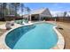 Stunning backyard oasis with a refreshing pool, outdoor seating, and a covered patio for al fresco dining at 7500 Gillespie Pl, Douglasville, GA 30135