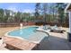Inviting backyard pool featuring a sun shelf, basketball hoop and lounge area, perfect for relaxation and entertainment at 7500 Gillespie Pl, Douglasville, GA 30135