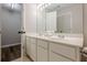 Bathroom featuring double vanity, large mirror, and walk-in closet at 9155 Nesbit Ferry Rd # 65, Alpharetta, GA 30022