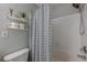 Full bathroom with shower over tub, striped curtain and floating decorative shelves at 9155 Nesbit Ferry Rd # 65, Alpharetta, GA 30022