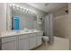 Full bathroom with shower over tub, double vanity, and modern light fixture at 9155 Nesbit Ferry Rd # 65, Alpharetta, GA 30022