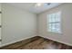Bedroom with wood-look flooring and a window that provides natural light at 9155 Nesbit Ferry Rd # 65, Alpharetta, GA 30022