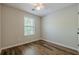 Bedroom with wood-look flooring and natural light from the window at 9155 Nesbit Ferry Rd # 65, Alpharetta, GA 30022