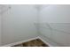 Walk-in closet with built-in shelving and LVP flooring at 9155 Nesbit Ferry Rd # 65, Alpharetta, GA 30022