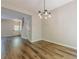 Bright dining room with modern light fixture and warm wood-look floors at 9155 Nesbit Ferry Rd # 65, Alpharetta, GA 30022