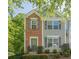 Charming two-story townhouse with brick accents, gray siding, and well-maintained landscaping at 9155 Nesbit Ferry Rd # 65, Alpharetta, GA 30022