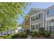 A well-maintained two-story townhouse with brick and siding exterior and landscaped front yard at 9155 Nesbit Ferry Rd # 65, Alpharetta, GA 30022