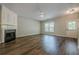 Comfortable living room featuring a fireplace, hardwood floors and ample natural light at 9155 Nesbit Ferry Rd # 65, Alpharetta, GA 30022