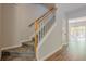 Carpeted staircase in neutral tones with wood railing connects main floor to upper level at 9155 Nesbit Ferry Rd # 65, Alpharetta, GA 30022