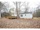 Backyard view of deck, lawn and home with a traditional roof and siding at 265 Winding Stream Trl, Hampton, GA 30228