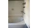Clean and functional bathroom showcasing a soaking tub with white tile surround at 265 Winding Stream Trl, Hampton, GA 30228