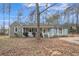 Charming single-story home with stone accents, a welcoming front porch, and a basketball hoop in the driveway at 265 Winding Stream Trl, Hampton, GA 30228