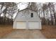 Spacious two-car garage with an attached driveway, perfect for vehicle storage and home projects at 265 Winding Stream Trl, Hampton, GA 30228
