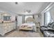 Serene main bedroom with ample closet space, a cozy seating area, and natural light at 265 Winding Stream Trl, Hampton, GA 30228