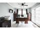 The well-lit office features a large desk, filing cabinets, and French doors to the exterior at 265 Winding Stream Trl, Hampton, GA 30228
