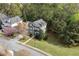 Aerial view of a beautiful home surrounded by lush greenery and mature trees at 997 Woodbury Rd, Canton, GA 30114