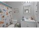 Charming bathroom with playful shower curtain, decor, and white vanity with storage space at 997 Woodbury Rd, Canton, GA 30114