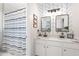 A bathroom with double sinks and mirrors, a shower with curtain, and patterned wall at 997 Woodbury Rd, Canton, GA 30114