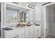 A bathroom with double sinks, white cabinets and drawers and an oversized mirror at 997 Woodbury Rd, Canton, GA 30114