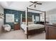 A primary bedroom featuring a four poster bed and an accent wall at 997 Woodbury Rd, Canton, GA 30114