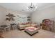 A playroom with vaulted ceilings, a couch, and a dollhouse at 997 Woodbury Rd, Canton, GA 30114