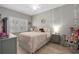 Serene bedroom features natural light, gray walls and wood floors, creating a peaceful retreat at 997 Woodbury Rd, Canton, GA 30114